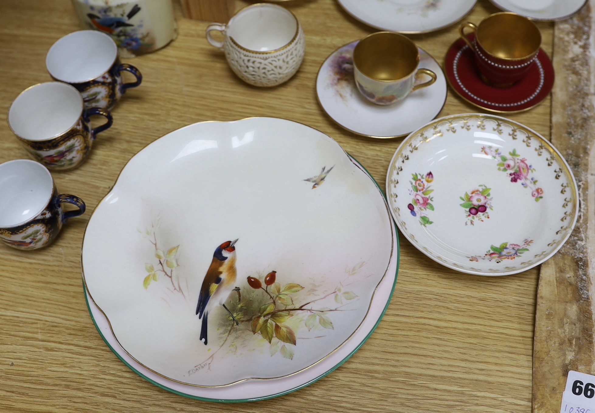 A large group of late 19th/early 20th century Royal Worcester tea wares, (some damage) including a signed bird painted pieces and signed fruit painted saucers